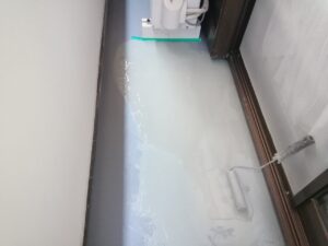 ベランダ防水工事 防水材をローラーで塗布している様子